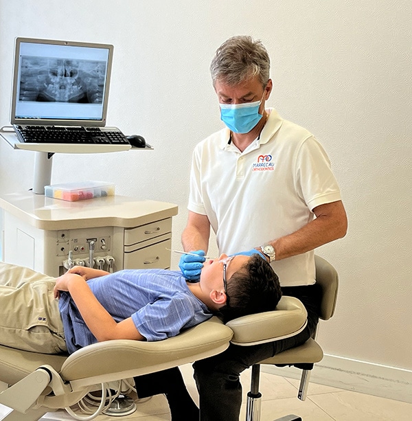 Dr. Tomas Marrecau installing braces
